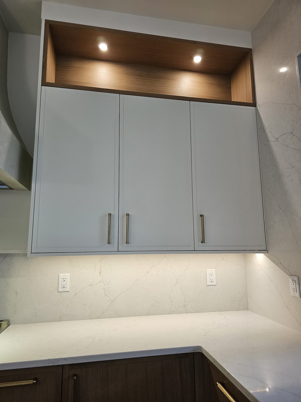 Finished kitchen cabinetry with a quartz countertop and a solid wood open shelf