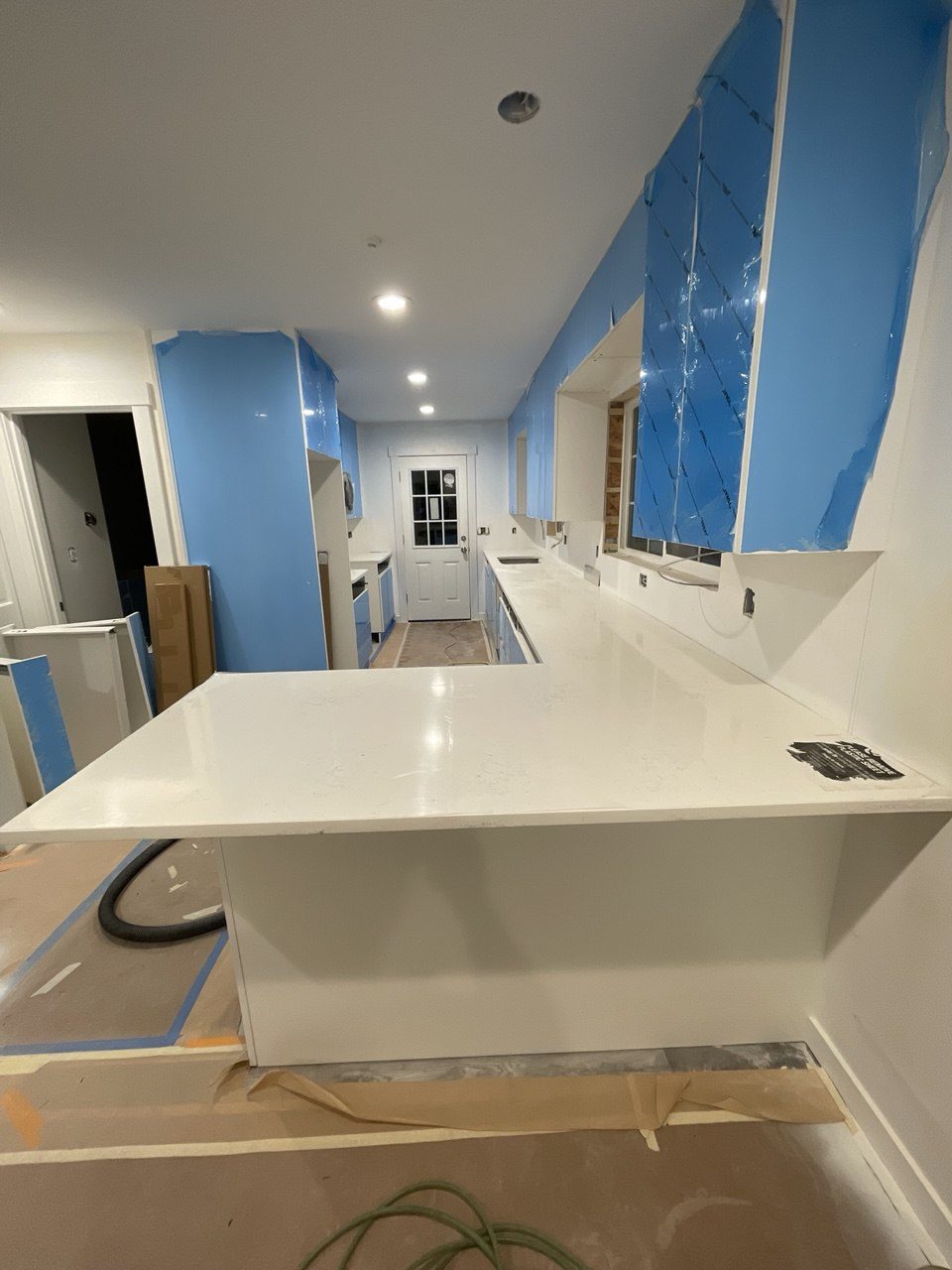 A waterfall-edge countertop being installed during a remodel